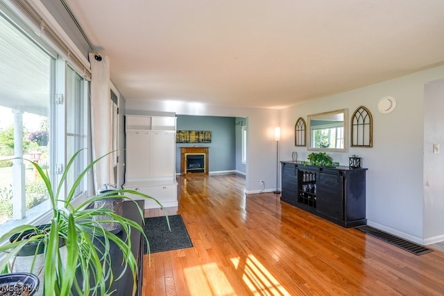 869 State Route 303, Streetsboro, OH 44241 - living room with a fireplace, light wood-style floors, and baseboards