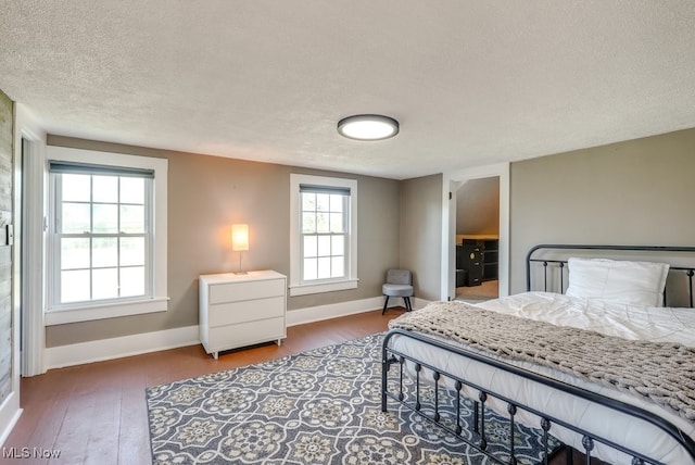 869 State Route 303, Streetsboro, OH 44241 - bedroom featuring wood finished floors, a textured ceiling, and baseboards