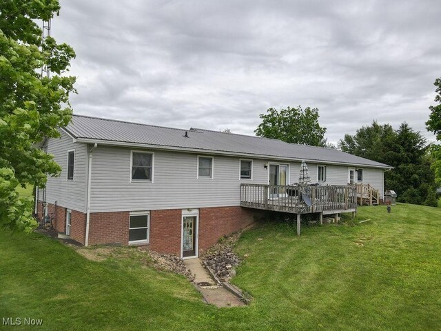 16000 Louisville St, Homeworth, OH 44634 - back of property with a yard, a deck, and metal roof