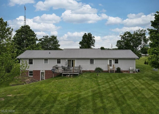 16000 Louisville St, Homeworth, OH 44634 - rear view of house featuring entry steps, a lawn, a wooden deck, and metal roof