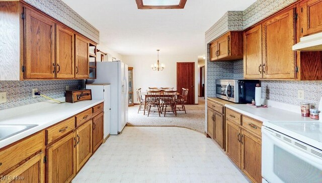 16000 Louisville St, Homeworth, OH 44634 - kitchen with white appliances, light countertops, brown cabinets, and backsplash