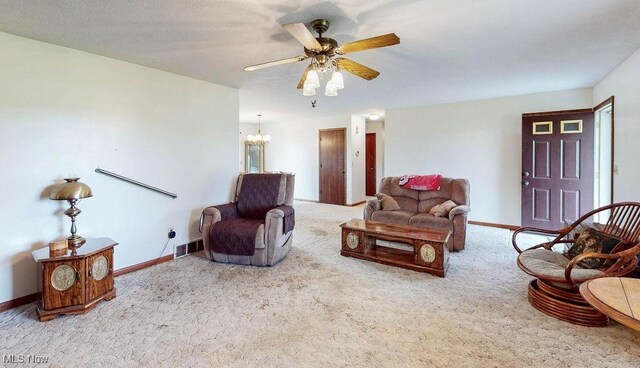 16000 Louisville St, Homeworth, OH 44634 - carpeted living area with a chandelier, ceiling fan, and baseboards