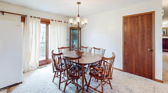 16000 Louisville St, Homeworth, OH 44634 - dining space with light colored carpet, a chandelier, and baseboards