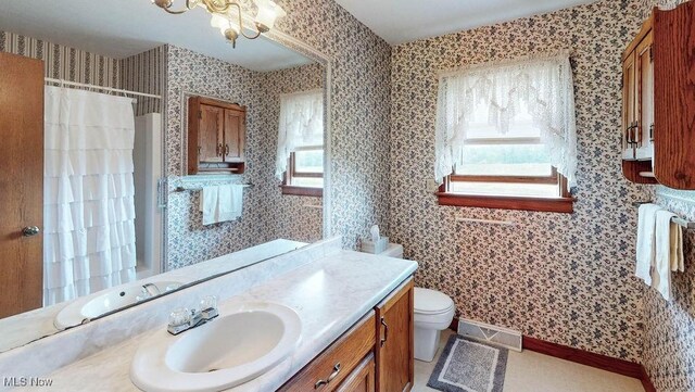16000 Louisville St, Homeworth, OH 44634 - bathroom with vanity, toilet, wallpapered walls, a shower with shower curtain, and a chandelier