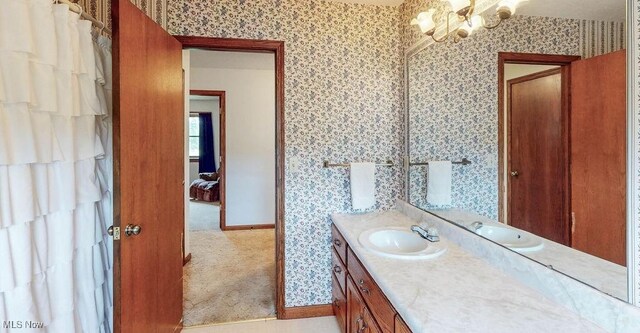 16000 Louisville St, Homeworth, OH 44634 - bathroom featuring wallpapered walls, vanity, a chandelier, and baseboards