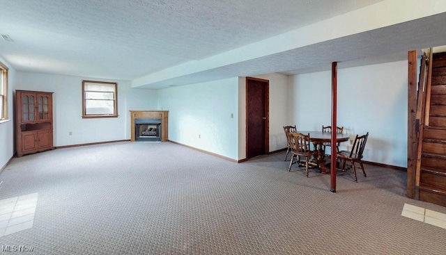 16000 Louisville St, Homeworth, OH 44634 - carpeted dining space with a fireplace with flush hearth, baseboards, a textured ceiling, and stairs