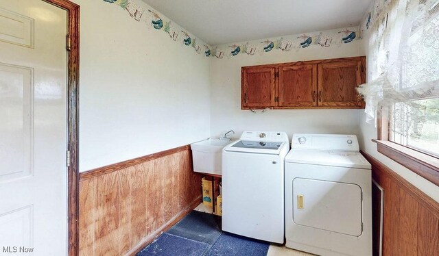 16000 Louisville St, Homeworth, OH 44634 - washroom with washing machine and dryer, cabinet space, a wainscoted wall, and tile patterned floors