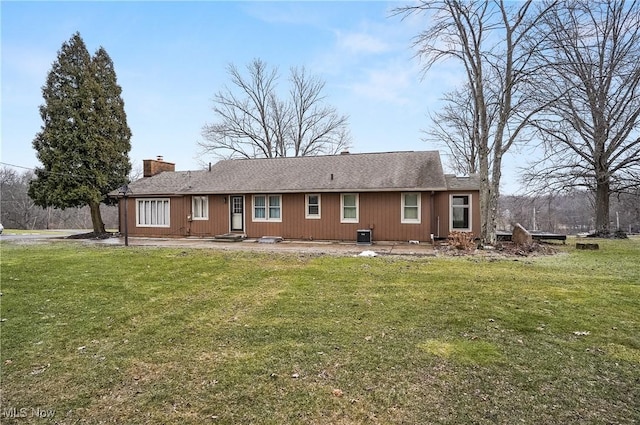 4017 Bellaire Ln, Peninsula, OH 44264 - rear view of property featuring a lawn, a chimney, and central AC unit