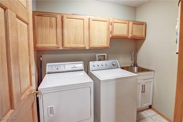 3936 Burgundy Bay Blvd W, Medina, OH 44256 - laundry area featuring cabinet space, washing machine and clothes dryer, light tile patterned floors, and a textured ceiling