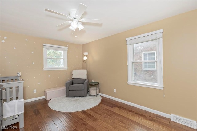 2381 Charney Rd, University Heights, OH 44118 - living area with wood finished floors, baseboards, and a ceiling fan