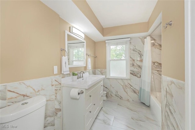 2381 Charney Rd, University Heights, OH 44118 - bathroom featuring toilet, tile walls, marble finish floors, wainscoting, and vanity