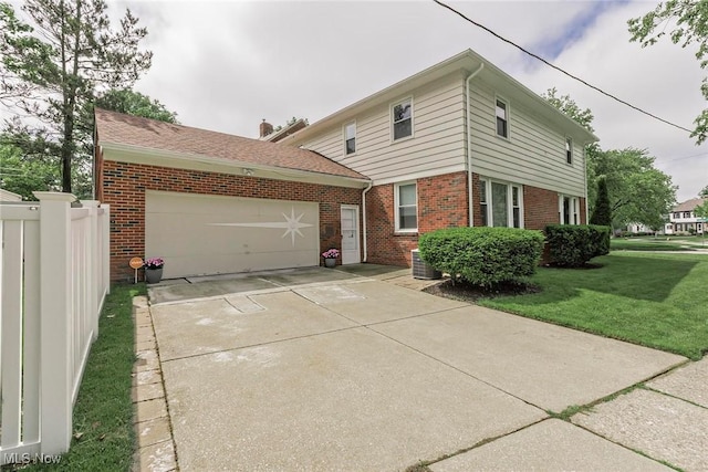 2381 Charney Rd, University Heights, OH 44118 - traditional home with brick siding, a garage, and driveway