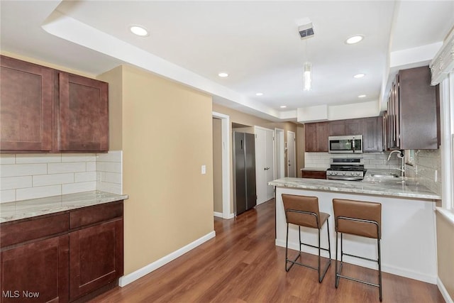 2381 Charney Rd, University Heights, OH 44118 - kitchen featuring stainless steel appliances, a sink, backsplash, a peninsula, and recessed lighting