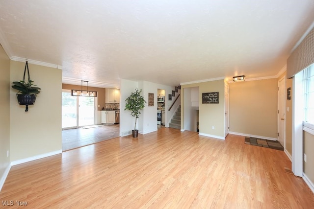726 N Fork Way, Brunswick Hills, OH 44212 - unfurnished living room with light wood-style floors, stairway, baseboards, a chandelier, and crown molding