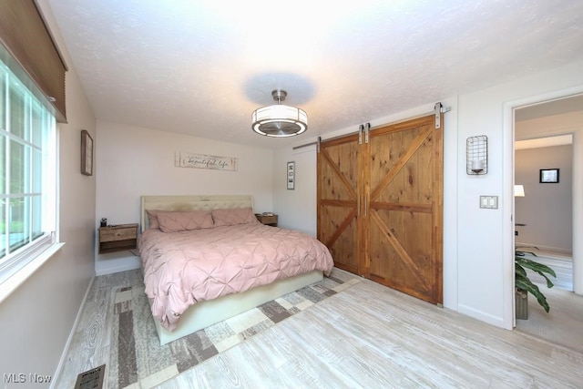 726 N Fork Way, Brunswick Hills, OH 44212 - bedroom featuring wood finished floors, baseboards, and a barn door