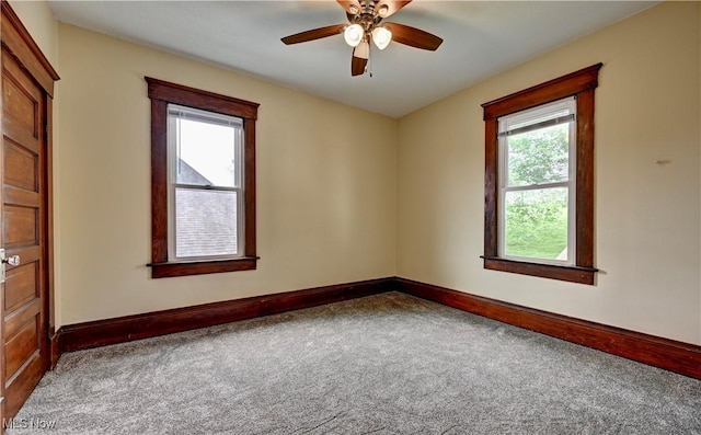 821 9th St SW, Massillon, OH 44647 - carpeted empty room featuring baseboards and a ceiling fan