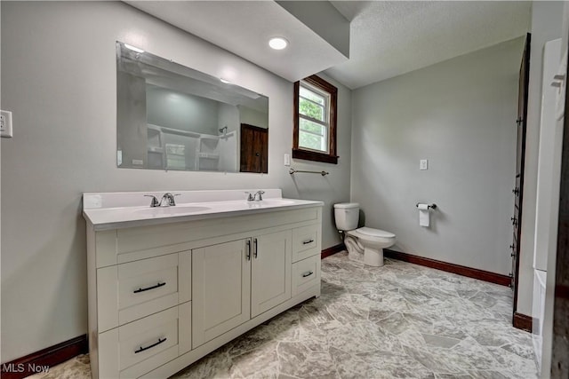 821 9th St SW, Massillon, OH 44647 - full bathroom with baseboards, double vanity, toilet, and a shower