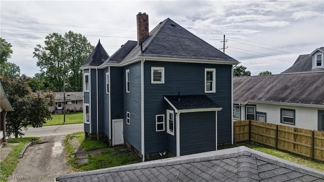 821 9th St SW, Massillon, OH 44647 - rear view of property with a chimney