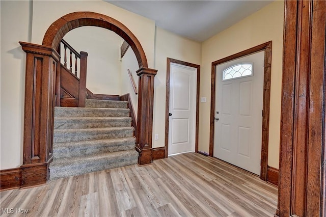821 9th St SW, Massillon, OH 44647 - entrance foyer with light wood-style floors, stairs, and baseboards