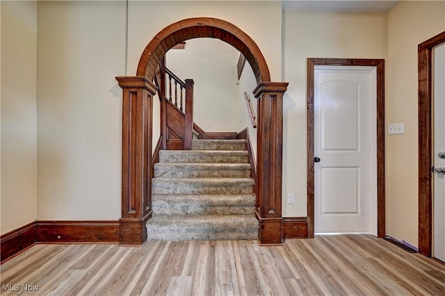 821 9th St SW, Massillon, OH 44647 - stairs featuring wood finished floors, baseboards, and arched walkways