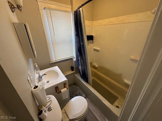 9705 Marah Ave, Cleveland, OH 44104 - bathroom featuring toilet, shower / bathtub combination with curtain, and vanity