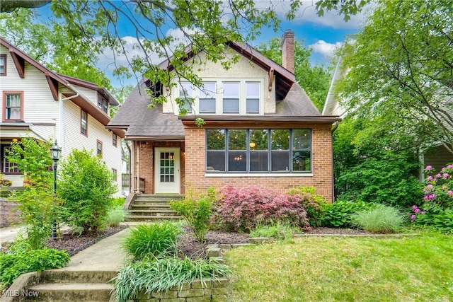37 Borton Ave, Akron, OH 44302 - view of front of house featuring a chimney, brick siding, and a front yard