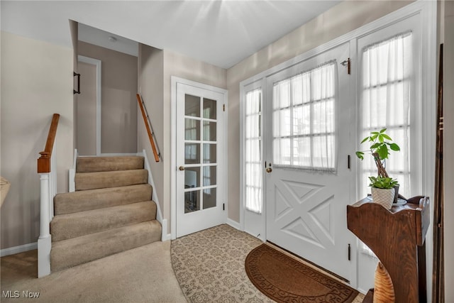 50 Luikart Dr, Euclid, OH 44123 - foyer featuring stairs, plenty of natural light, carpet, and baseboards