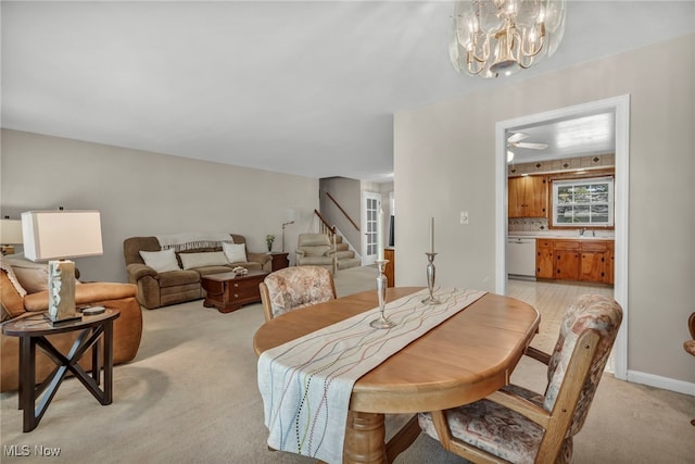 50 Luikart Dr, Euclid, OH 44123 - dining room with light colored carpet, stairway, and a chandelier
