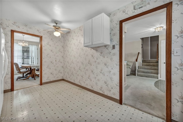 50 Luikart Dr, Euclid, OH 44123 - spare room with a ceiling fan, stairs, baseboards, a chandelier, and light flooring