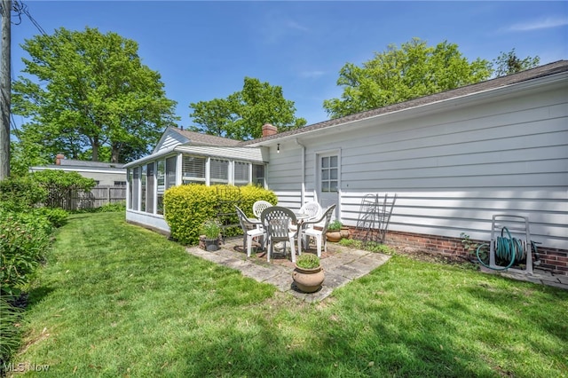 50 Luikart Dr, Euclid, OH 44123 - back of property with a chimney, a patio area, and a sunroom