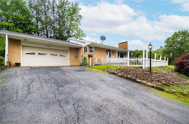 600 Elson St, East Liverpool, OH 43920 - single story home featuring brick siding, a chimney, asphalt driveway, and an attached garage