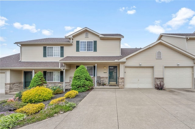 808 Doty Dr, Wadsworth, OH 44281 - traditional-style house featuring concrete driveway, an attached garage, roof with shingles, and covered porch