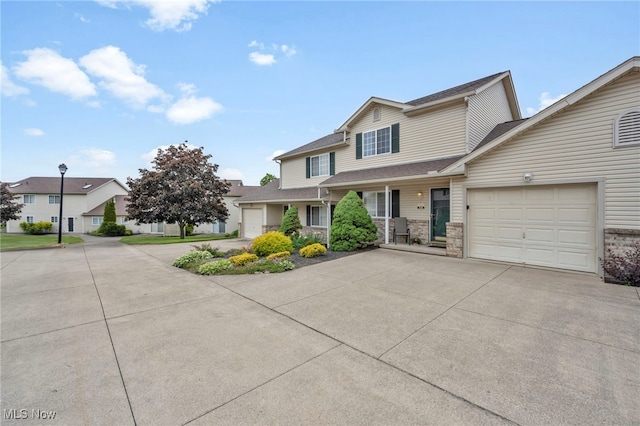 808 Doty Dr, Wadsworth, OH 44281 - view of front of house featuring concrete driveway, an attached garage, a shingled roof, and a residential view