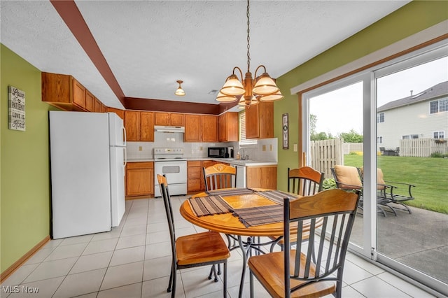 808 Doty Dr, Wadsworth, OH 44281 - dining space featuring a chandelier, light tile patterned flooring, a textured ceiling, and baseboards