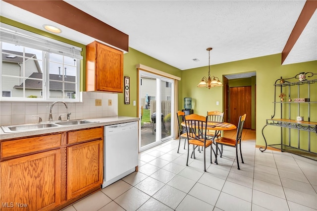 808 Doty Dr, Wadsworth, OH 44281 - kitchen featuring dishwasher, a sink, plenty of natural light, tasteful backsplash, and a textured ceiling