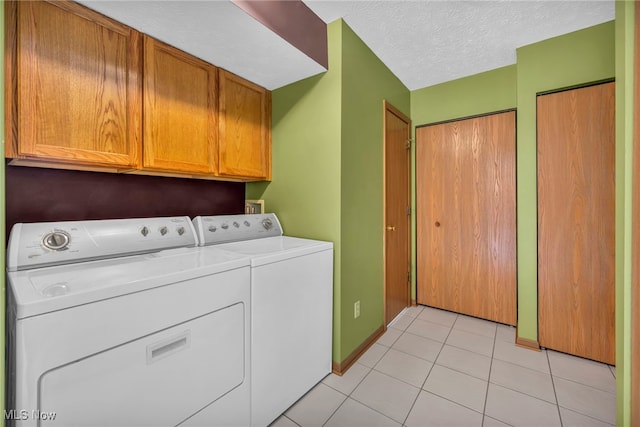808 Doty Dr, Wadsworth, OH 44281 - laundry room featuring cabinet space, washing machine and clothes dryer, light tile patterned floors, baseboards, and a textured ceiling