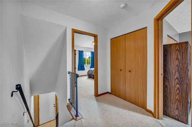 808 Doty Dr, Wadsworth, OH 44281 - corridor featuring an upstairs landing, a textured ceiling, light carpet, and baseboards