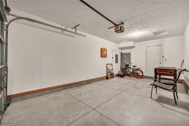 808 Doty Dr, Wadsworth, OH 44281 - garage featuring baseboards, electric panel, and a garage door opener
