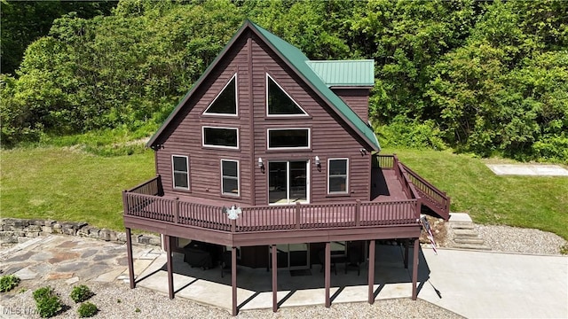 693 Evening Star Ave SE, East Canton, OH 44730 - rear view of house featuring a deck, a patio, and a lawn