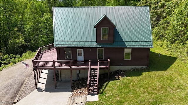 693 Evening Star Ave SE, East Canton, OH 44730 - view of front of home with stairway, a deck, a front lawn, metal roof, and driveway