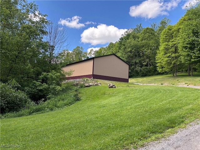 693 Evening Star Ave SE, East Canton, OH 44730 - view of home's exterior with an outbuilding, a lawn, and a detached garage