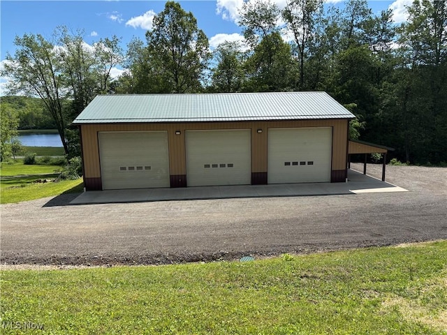 693 Evening Star Ave SE, East Canton, OH 44730 - garage featuring a detached garage and a water view