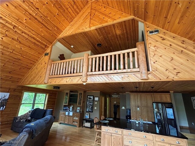 693 Evening Star Ave SE, East Canton, OH 44730 - kitchen featuring wood ceiling, dark countertops, high vaulted ceiling, wood finished floors, and wood walls