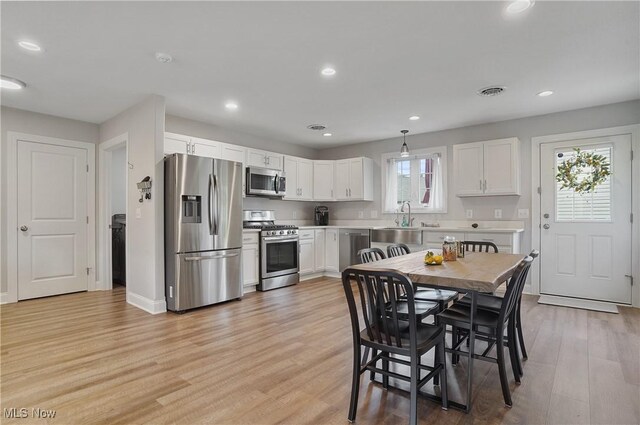 603 S Raccoon Rd Unit 13, Austintown, OH 44515 - kitchen featuring stainless steel appliances, healthy amount of natural light, light wood-style flooring, white cabinets, and recessed lighting