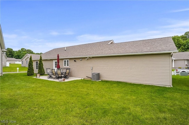 603 S Raccoon Rd Unit 13, Austintown, OH 44515 - rear view of property featuring a lawn, a patio, central air condition unit, and a shingled roof