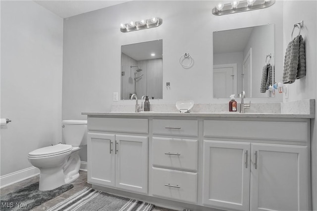 603 S Raccoon Rd Unit 13, Austintown, OH 44515 - full bath with double vanity, toilet, a shower with shower door, and baseboards