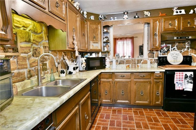 172 Camrose Dr, Niles, OH 44446 - kitchen with black appliances, light countertops, a sink, brown cabinets, and under cabinet range hood