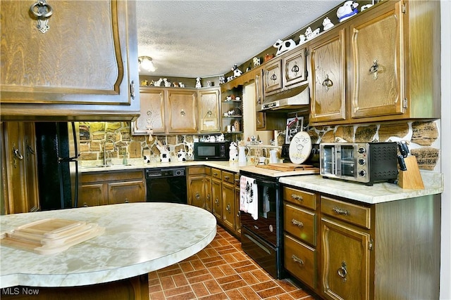 172 Camrose Dr, Niles, OH 44446 - kitchen with black appliances, a sink, under cabinet range hood, light countertops, and a textured ceiling