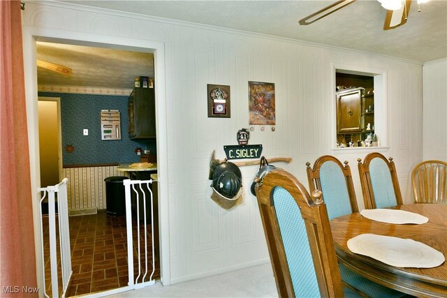 172 Camrose Dr, Niles, OH 44446 - dining room featuring wallpapered walls, crown molding, ceiling fan, brick patterned flooring, and baseboards