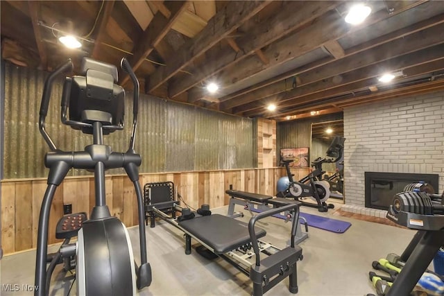 4346 Selhurst Rd, North Olmsted, OH 44070 - workout room featuring wooden walls and a brick fireplace
